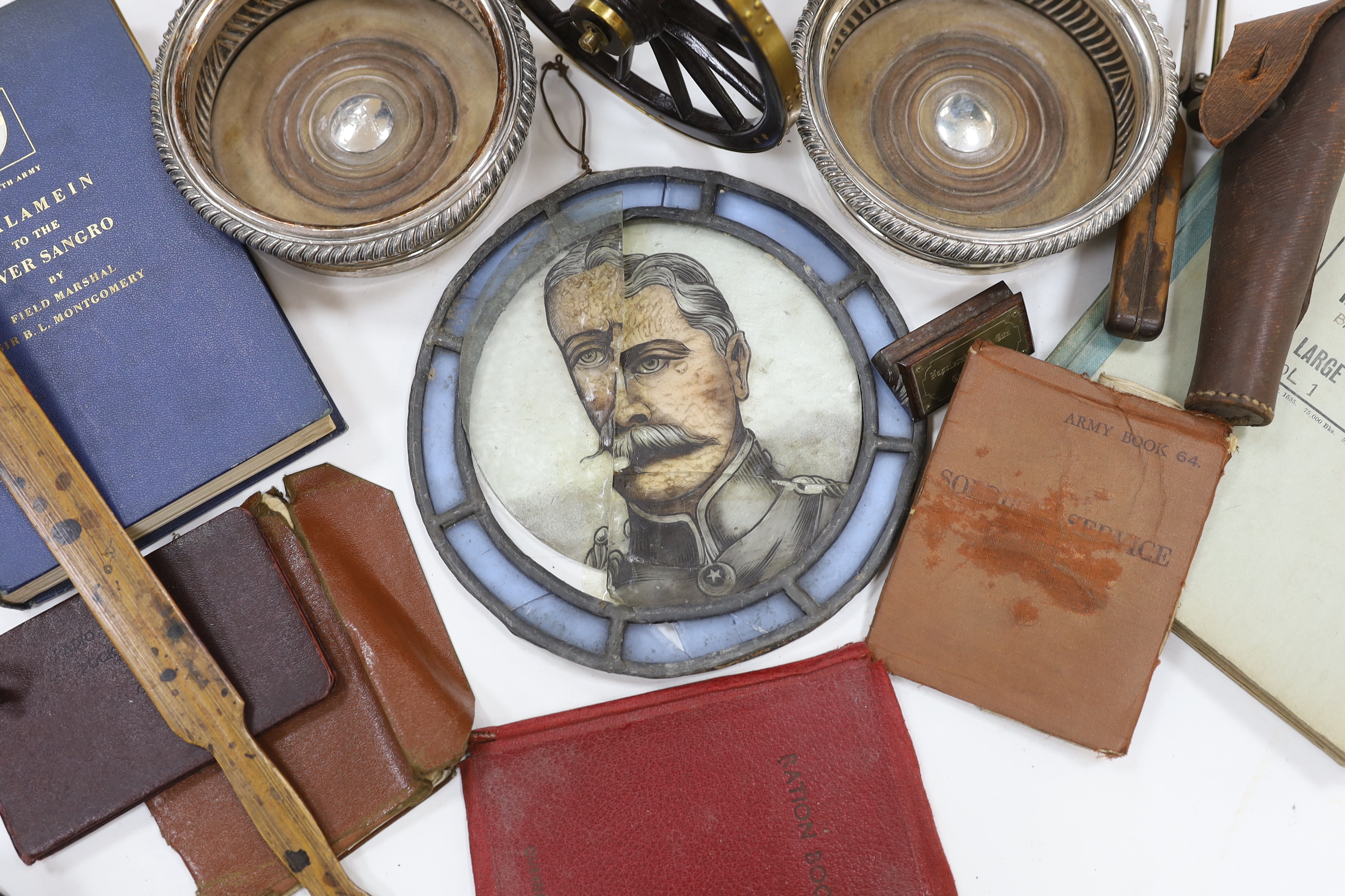 A collection of militaria, including a brass model of a Napoleonic era field gun, a stained glass panel, a Royal Air Force notebook, Civil Defence leaflets, etc.